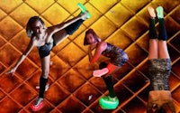 a group of dancers doing acrobatics in front of a glowing background