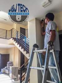a man is working on a ladder in a house
