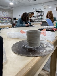 a group of people working at a table in a workshop