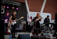 image may contain person, on stage and playing a musical instrument