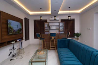 a living room with a blue couch and tv