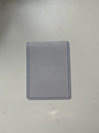 a square piece of plastic on a white surface