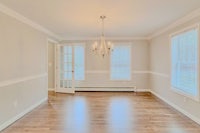 empty living room with hardwood floors and a chandelier