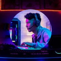 a man wearing headphones is playing a game on a computer