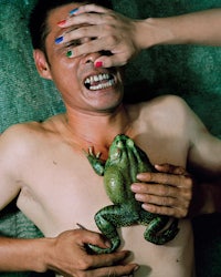 a man holding a frog