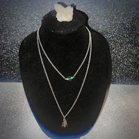 a mannequin with a necklace and a butterfly on it