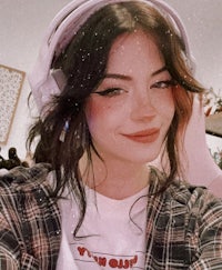 a girl wearing headphones and a plaid shirt