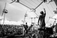 a black and white photo of a group of people at a concert