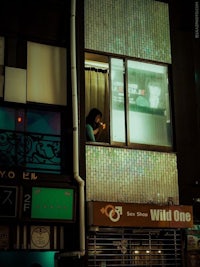 a man looking out of a window in a building