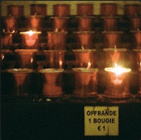 a row of candles in a church