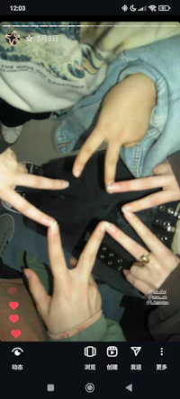 a group of people making a peace sign on a phone