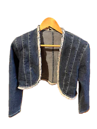 a denim jacket hanging on a hanger