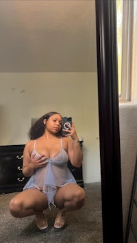 a woman is taking a selfie in a mirror