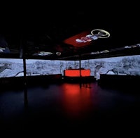 a dark room with a large projection screen