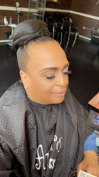 a woman is getting her hair done in a salon