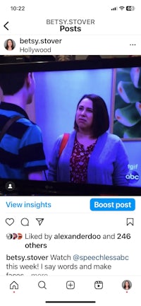 a woman is talking to someone on a tv screen