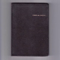 a black leather book with the word christianity written on it