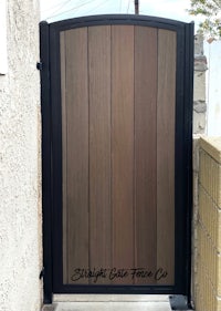 a wooden gate in front of a house