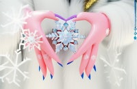 a pink hand holding a snowflake in the shape of a heart
