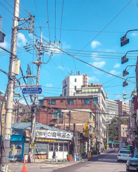 a street in a city with a lot of wires and buildings