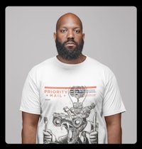 a man with a beard wearing a t - shirt that says 'priority mail'