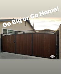 a wooden gate with the words go big or go home