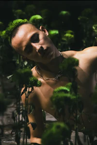 a man posing in a field of flowers