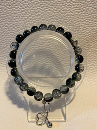 a bracelet with black and white beads on it