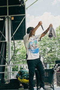 a man standing on stage with a microphone in his hand