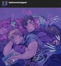 two men laying in bed with a cat on their lap