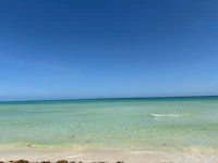 a beach with clear water and sand