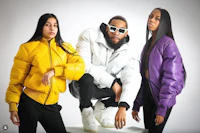 three people in yellow jackets posing for a photo