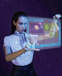 a woman is holding a t - shirt with a holographic screen