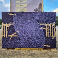 a purple and gold painting on the side of a tent