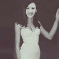 a woman in a white dress is posing for a photo