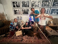 a group of people posing in front of a teepee