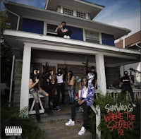 a group of people standing on the steps of a house