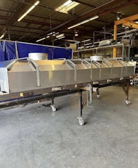 a large stainless steel machine in a warehouse