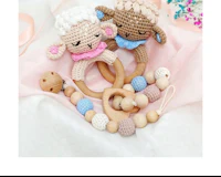 a crocheted sheep and bead teether set