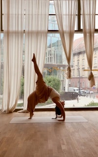 a woman doing yoga in front of a window