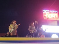 a group of people playing music on a stage at night