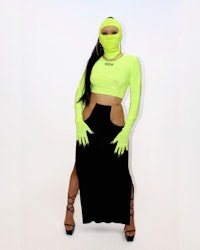a woman in a neon green outfit posing for a photo