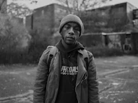 a black and white photo of a man in a beanie