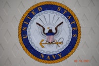 the united states navy logo is shown on a white wall