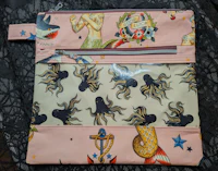 a pink pouch with a mermaid on it