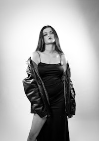 a woman in a black dress posing for a photo