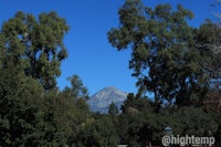 a mountain is seen through the trees in a park