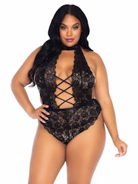 a plus size woman wearing a black lace lingersuit