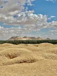egyptian desert with sand dunes and clouds in the sky