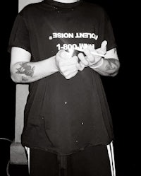 a man with tattoos wearing a t - shirt